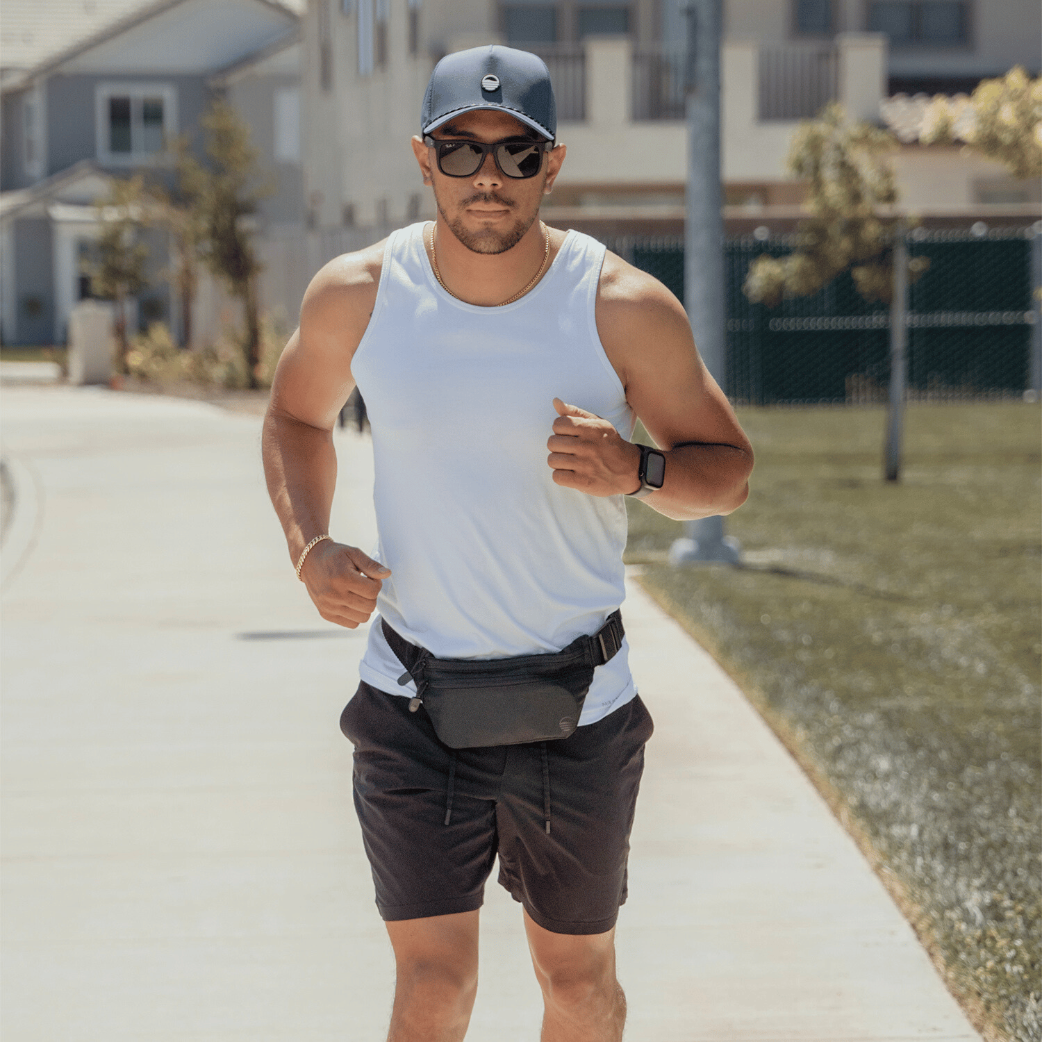 Black Runner Sling worn by a man running, paired with a navy Porter Lite hat.