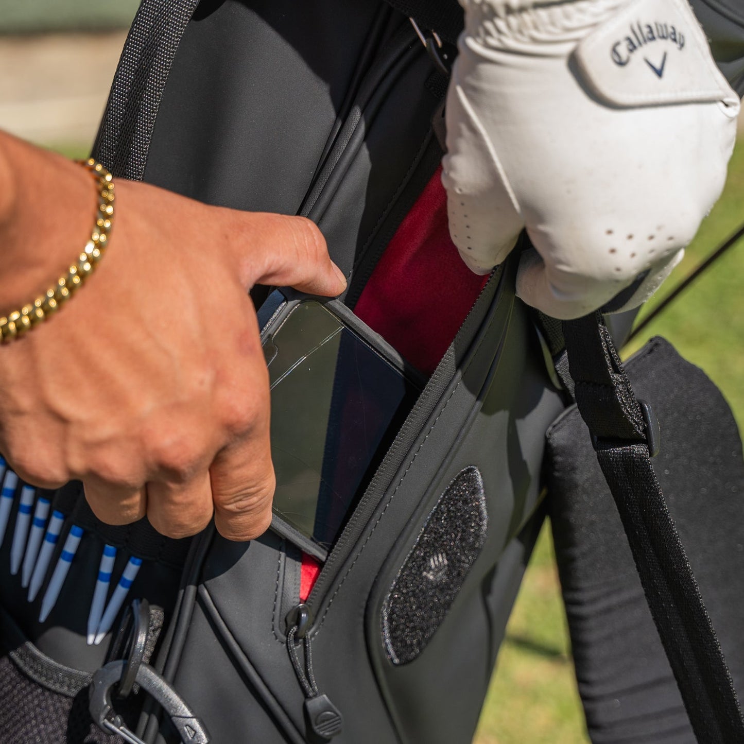 Black S-Class on course and detailed shot of valuables pouch