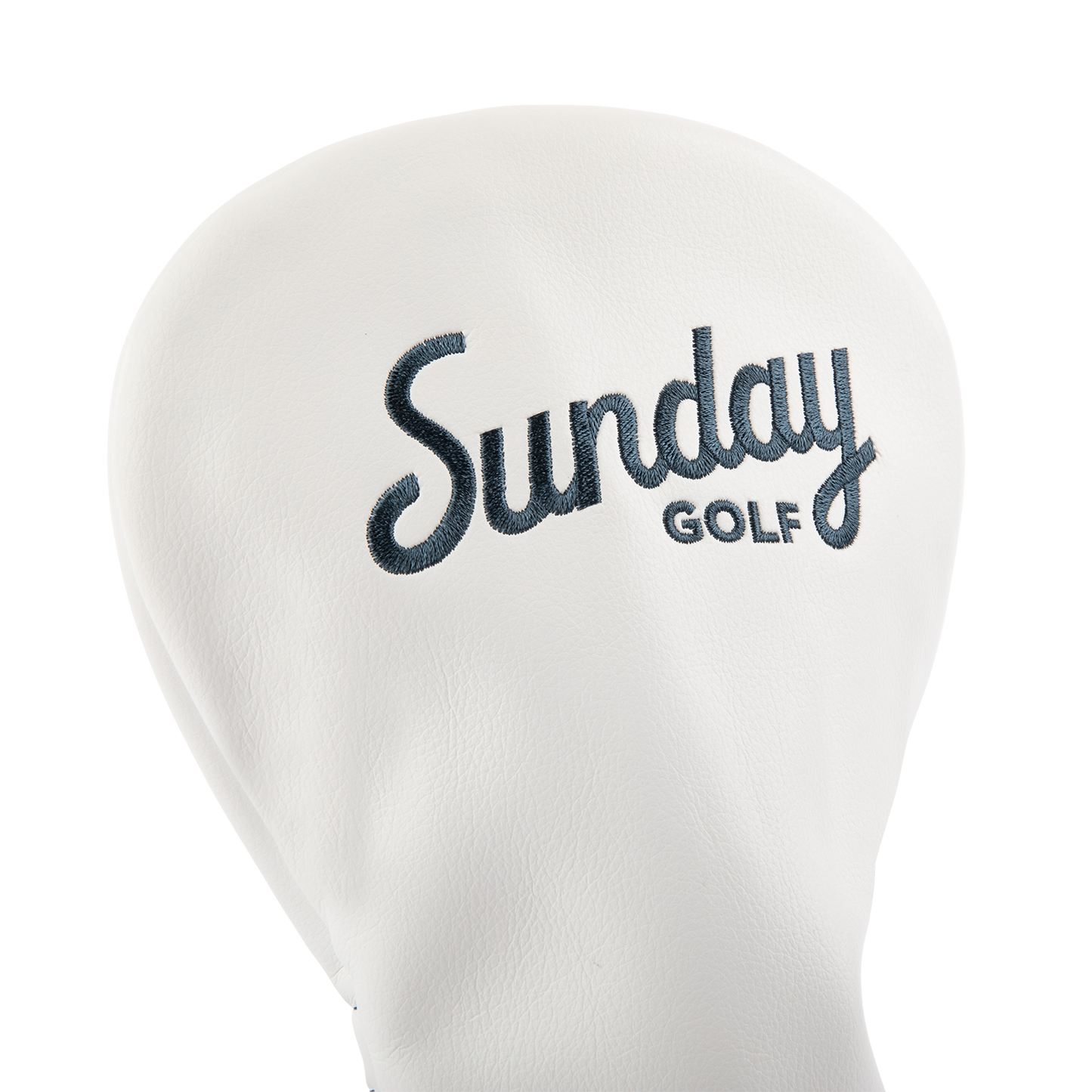 Close up shot of driver golf headcover in white and navy vegan leather showing its material and Sunday Golf logo