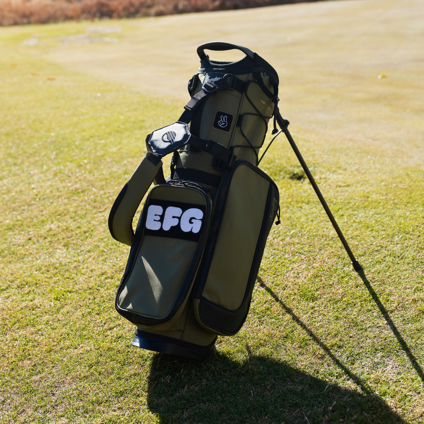 Sunday Golf's Paton Green Recess Kids Golf Bag, featuring 'EFG' patches and key design features.