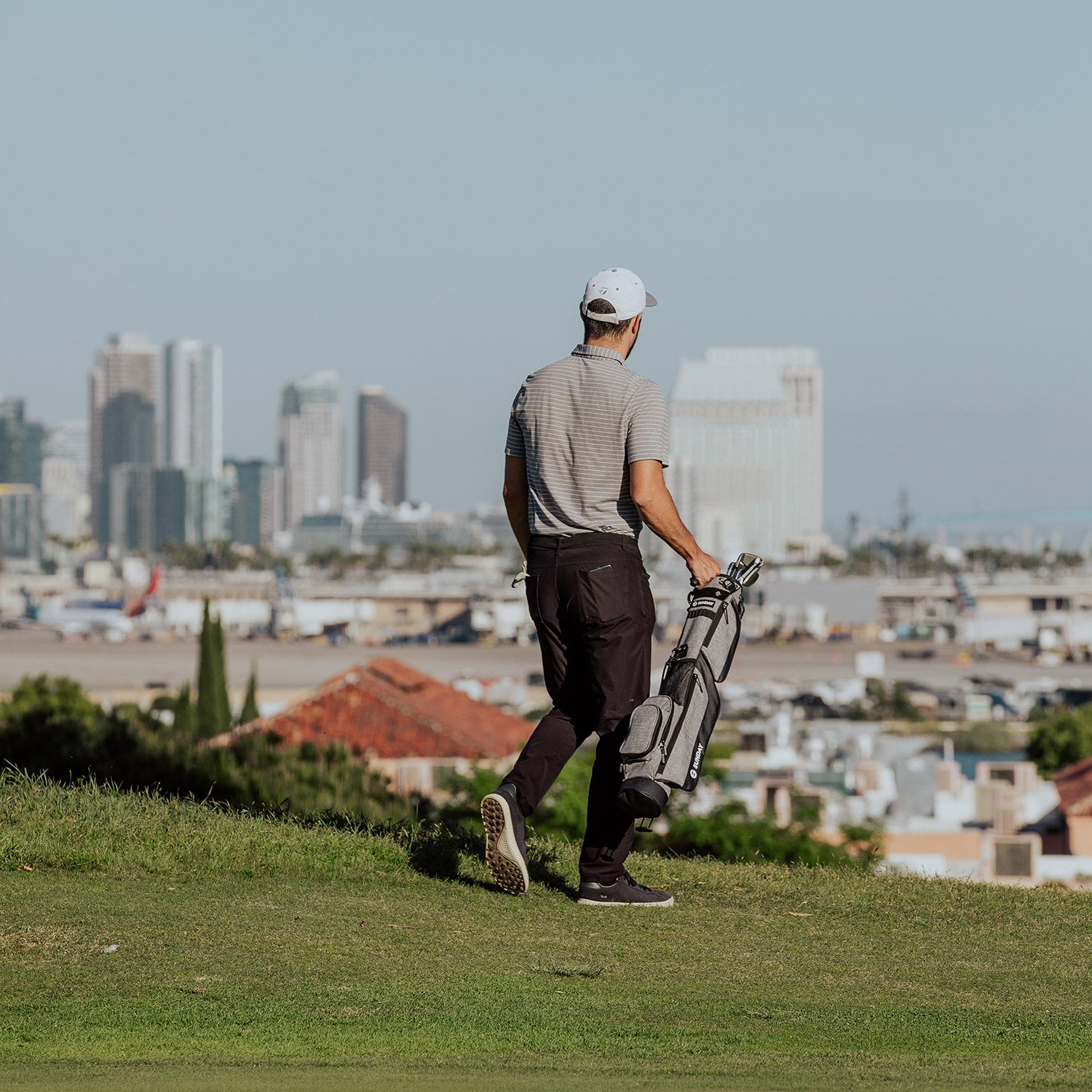 golfer carrying Heather Gray Loma Bag