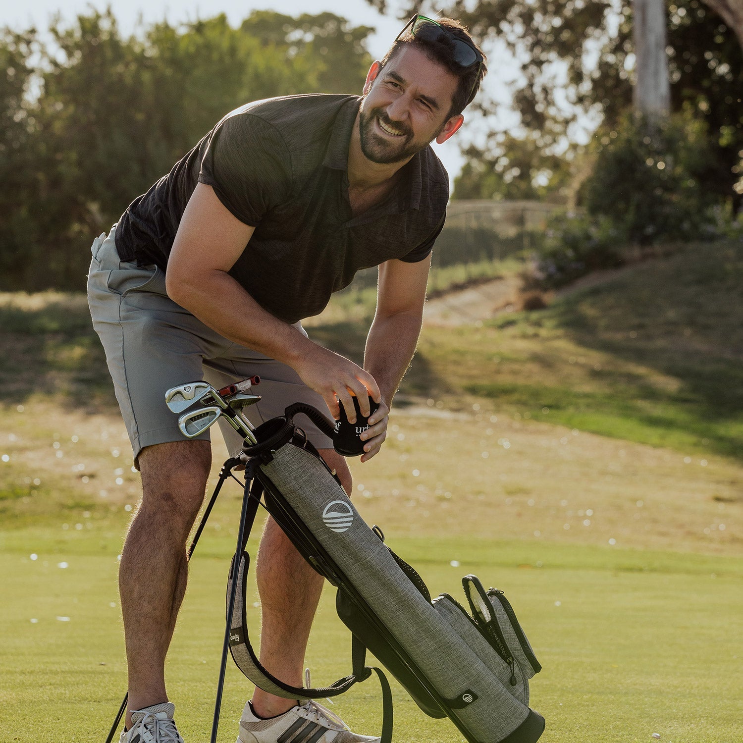 man with Heather Gray Loma golf bag by Sunday Golf
