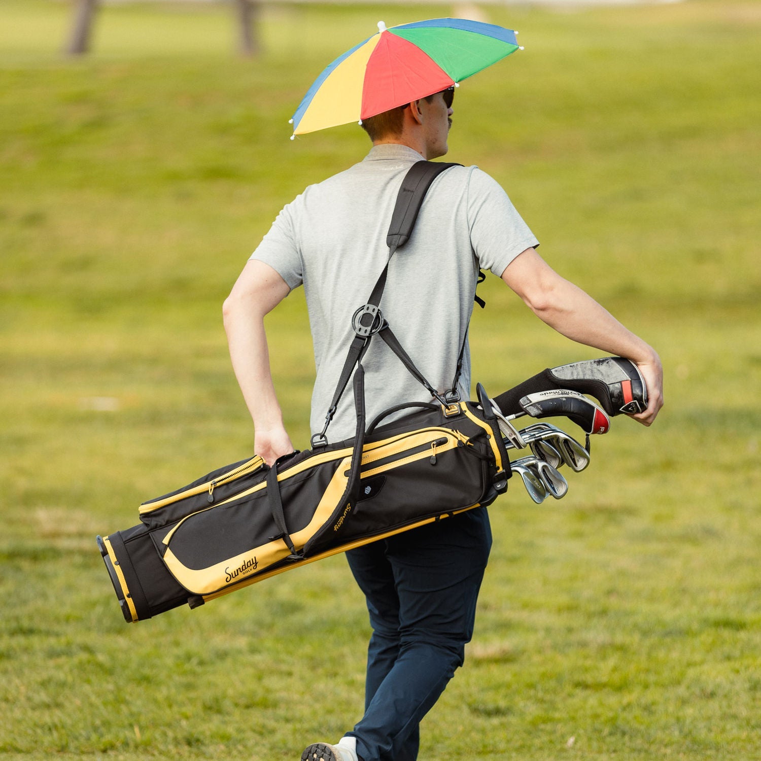 El camino black and yellow carried by a guy using double strap lifestyle photo