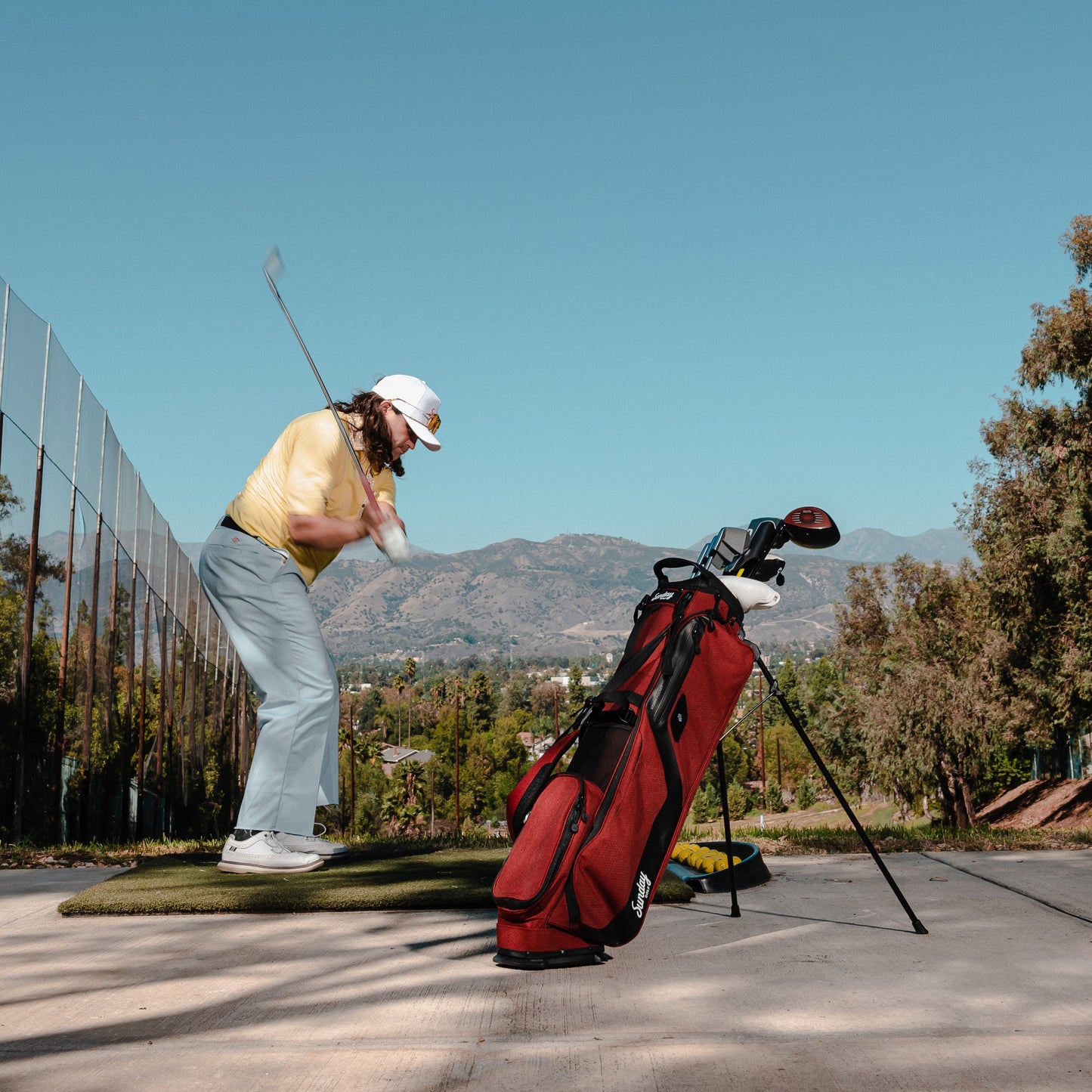 deep red burgundy el camino golf bag at driving range