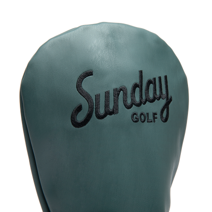 Close up shot of driver golf headcover in midnight green vegan leather showing its material and Sunday Golf logo
