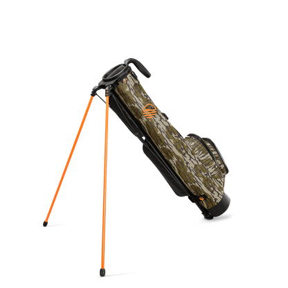 A full shot of standing Loma golf bag in mossy oak bottomland facing backward