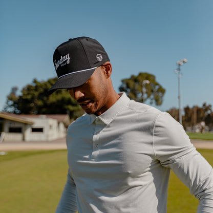 man wearing black rope hat by Sunday Golf