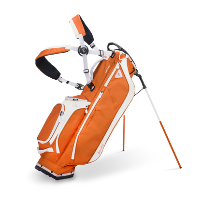 A full front shot of standing Ryder golf bag in burnt orange with double strap