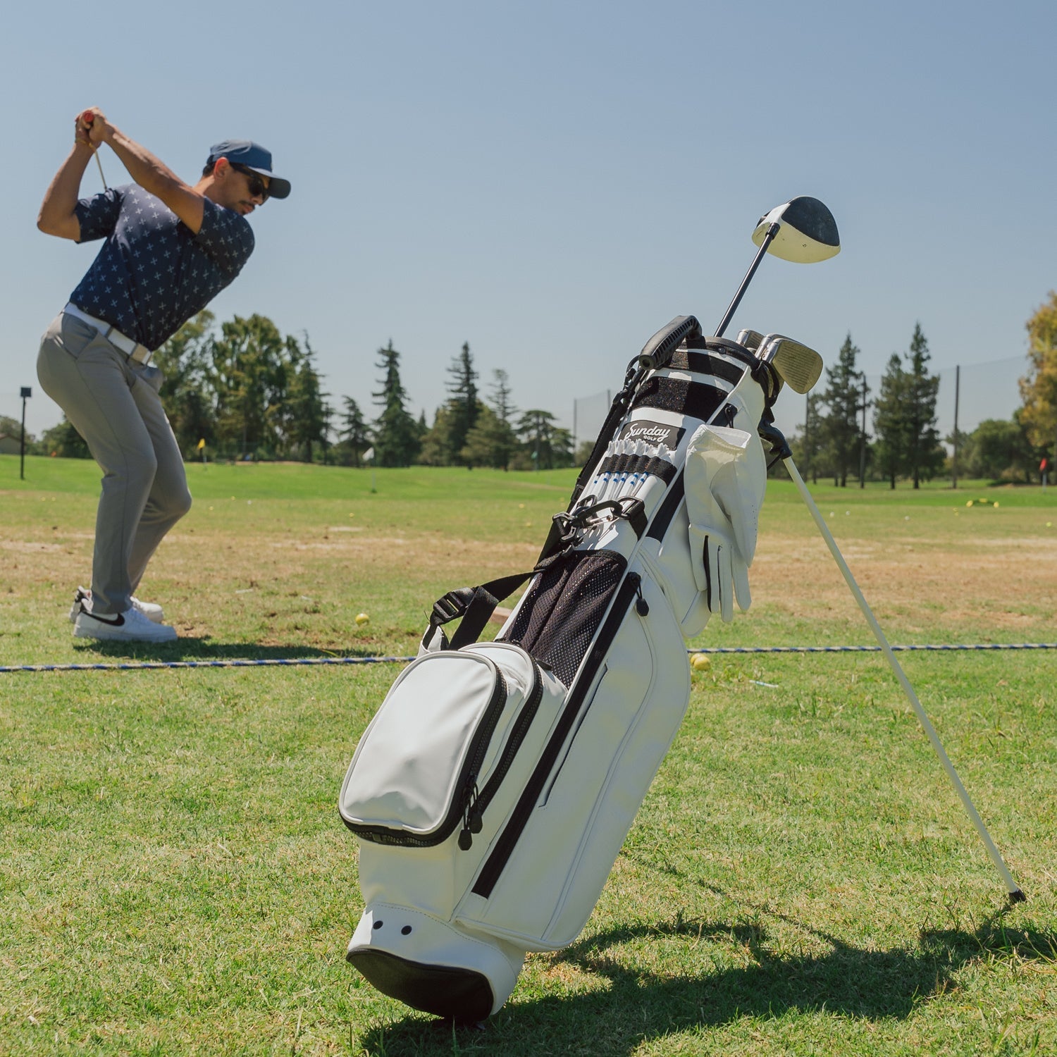 Loma XL S Class White full view shot with a guy playing golf on the side
