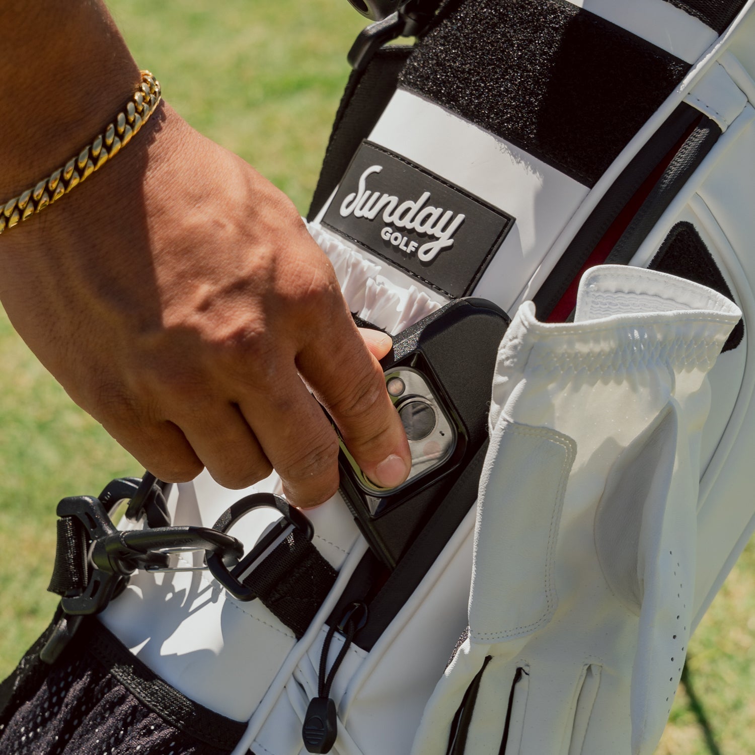 Loma XL S Class White detailed shot of the valuables pouch and an iphone being put inside