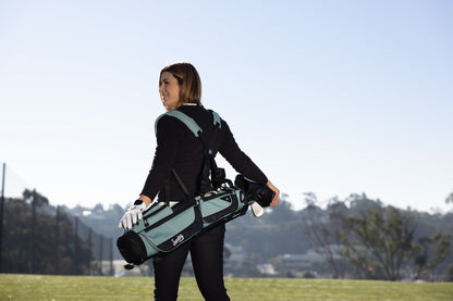 woman carrying Seafoam Green Loma XL golf bag by Sunday Golf using double shoulder strap 